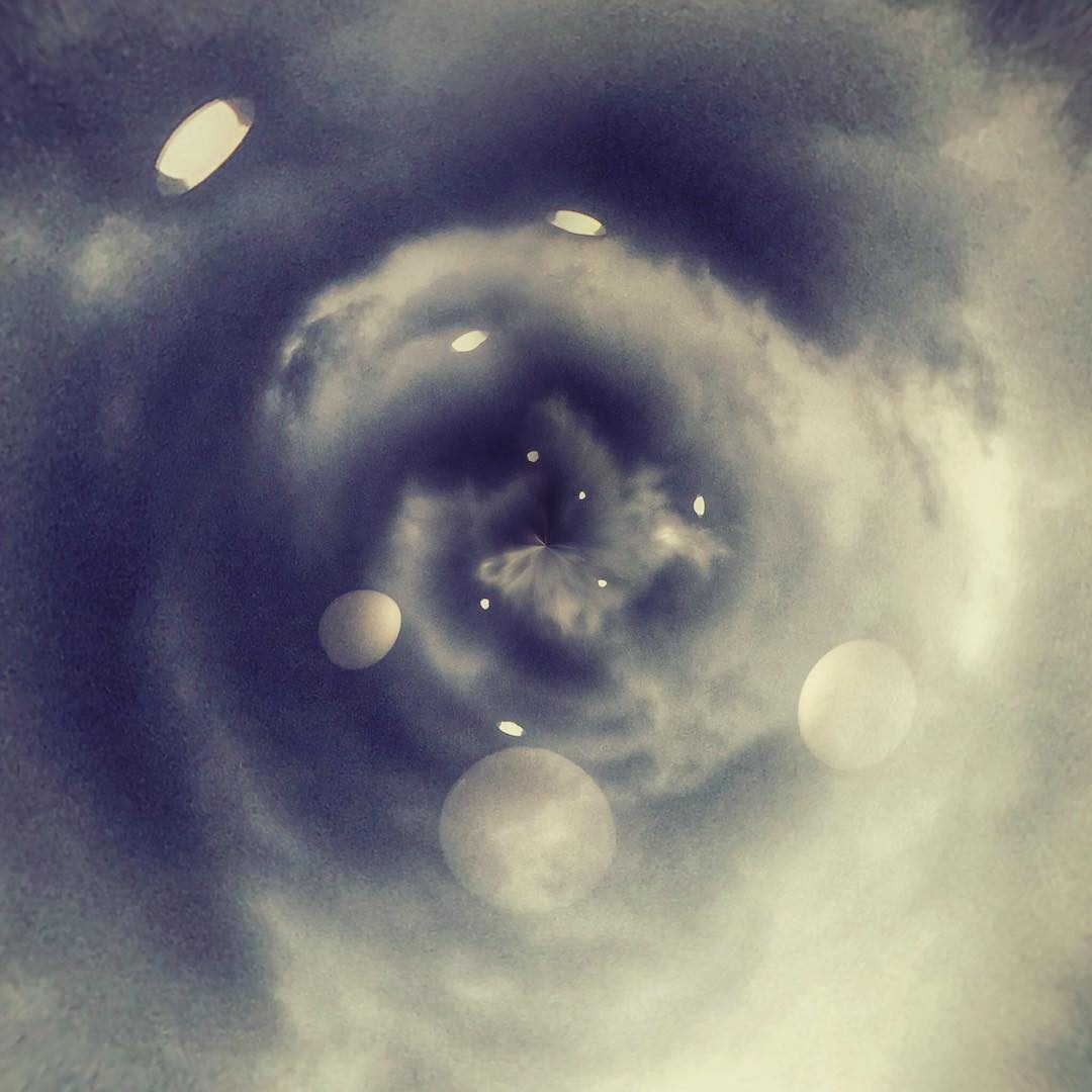 swirling clouds with floating orbs