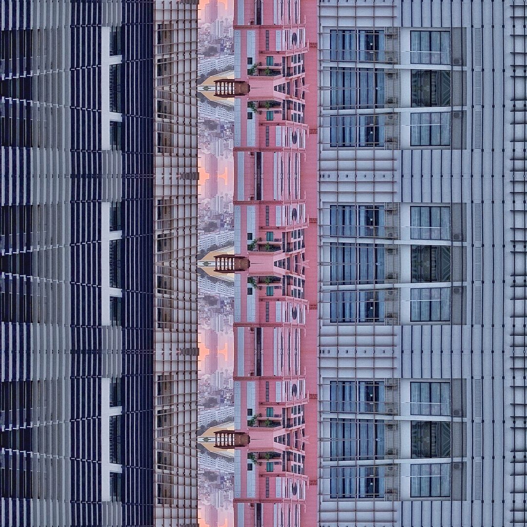Abstract vertical cityscape with mirrored pink building