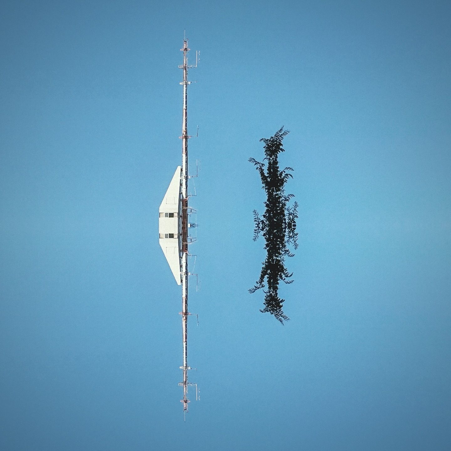 Antenna tower and tree against clear sky