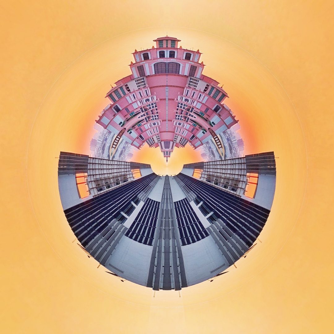 Circular fisheye cityscape with central tower