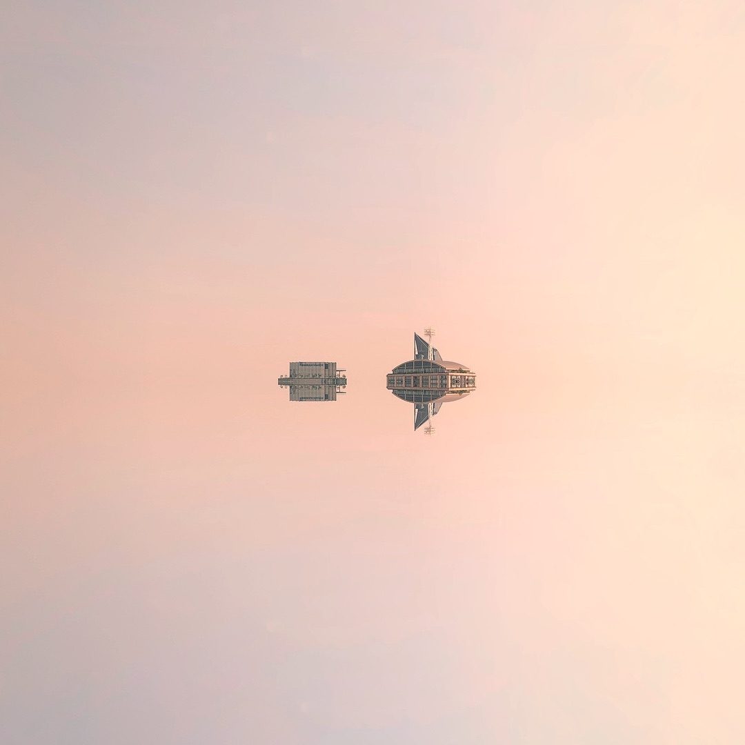 Two aircraft flying in pastel sky